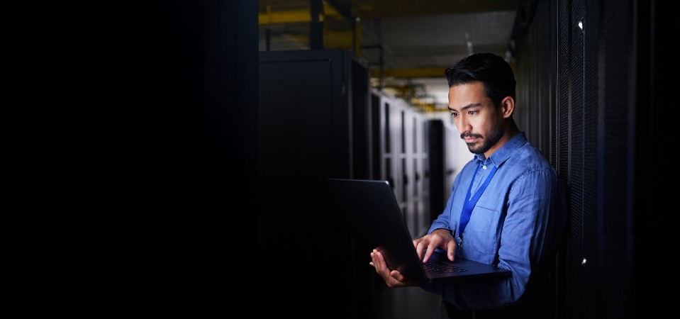 An IT manager and network specialist configures a physical security system in a data center